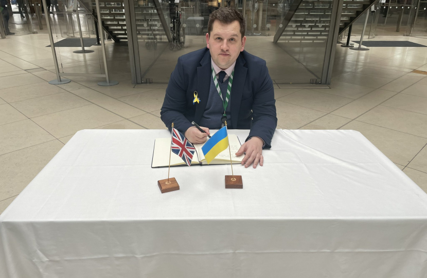 Louie French signing Book of Solidarity for Ukraine